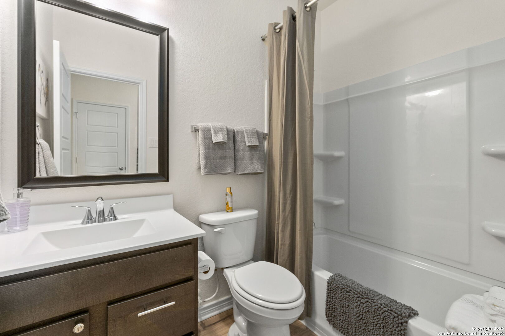 14839 Vance Jackson Road, Unit 1101 San Antonio, TX 78249 - Photo 14 of 31 a bathroom with a sink a toilet and shower