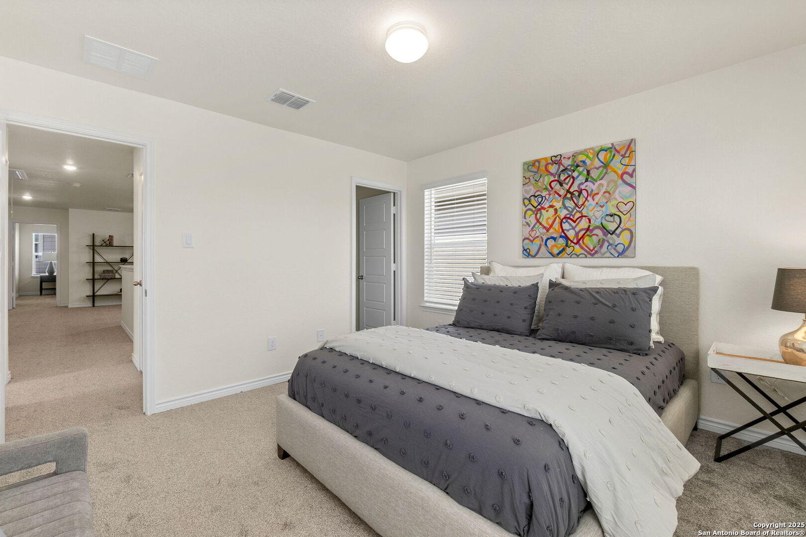 14839 Vance Jackson Road, Unit 1101 San Antonio, TX 78249 - Photo 17 of 31 a bedroom with a bed and a painting on the wall
