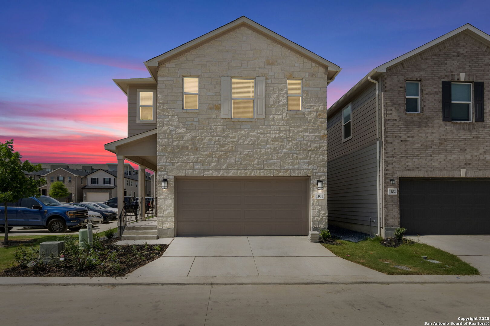 14839 Vance Jackson Road, Unit 1101 San Antonio, TX 78249 - Photo 2 of 31 a front view of a house with a yard and garage
