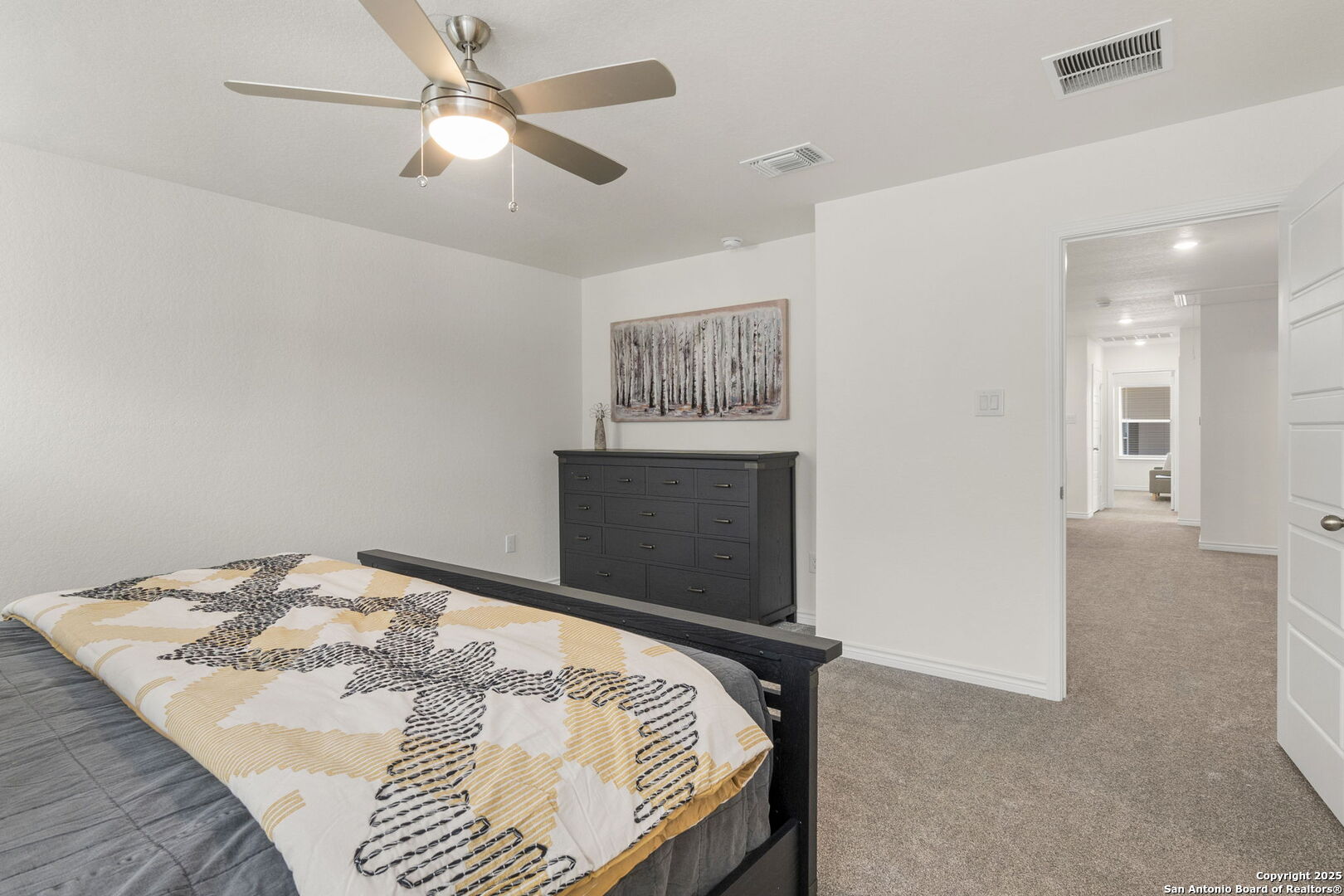 14839 Vance Jackson Road, Unit 1101 San Antonio, TX 78249 - Photo 24 of 31 a bed sitting in a room and chandelier fan