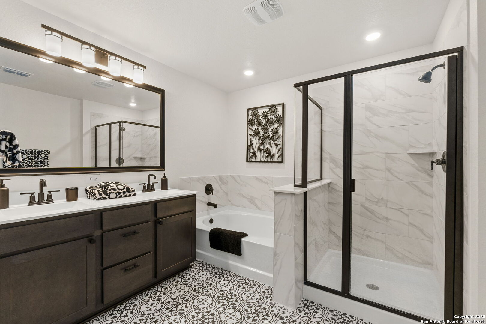 14839 Vance Jackson Road, Unit 1101 San Antonio, TX 78249 - Photo 25 of 31 a bathroom with a double vanity sink a toilet a mirror and shower