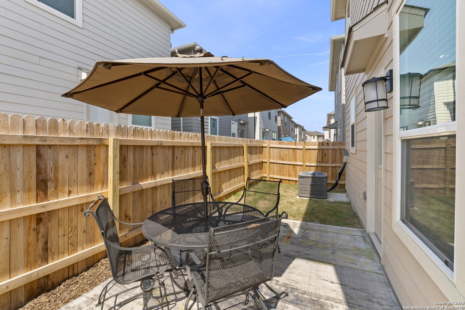 14839 Vance Jackson Road, Unit 1101 San Antonio, TX 78249 - Photo 30 of 31 a blue swimming pool with a table and chairs under an umbrella