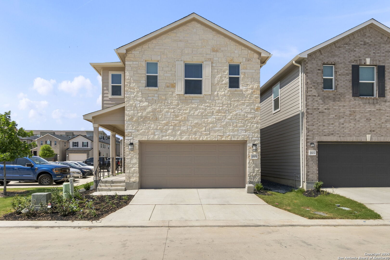 14839 Vance Jackson Road, Unit 1101 San Antonio, TX 78249 - Photo 3 of 31 a front view of a house with a yard and garage