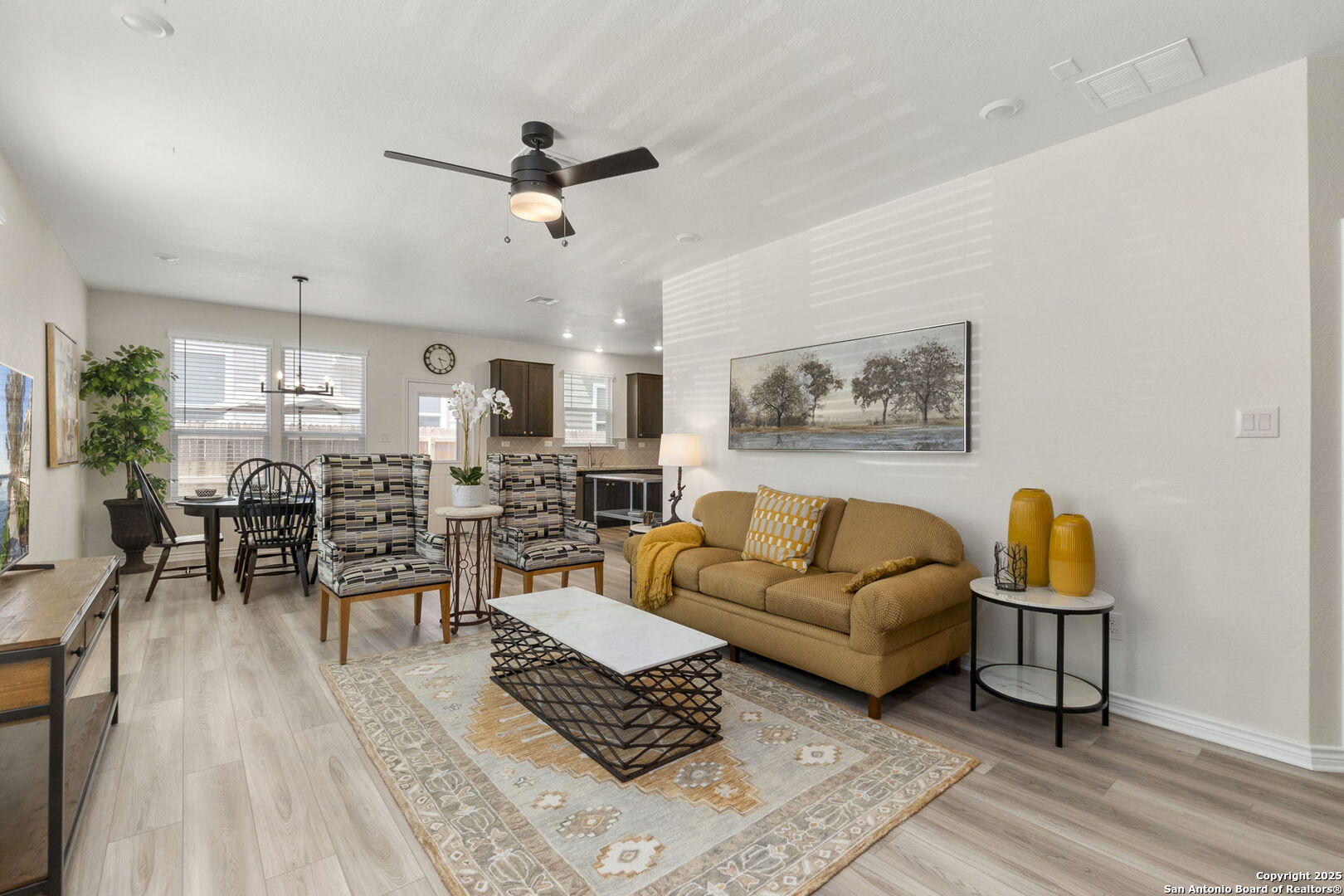 14839 Vance Jackson Road, Unit 1101 San Antonio, TX 78249 - Photo 4 of 31 a living room with furniture kitchen view and a wooden floor