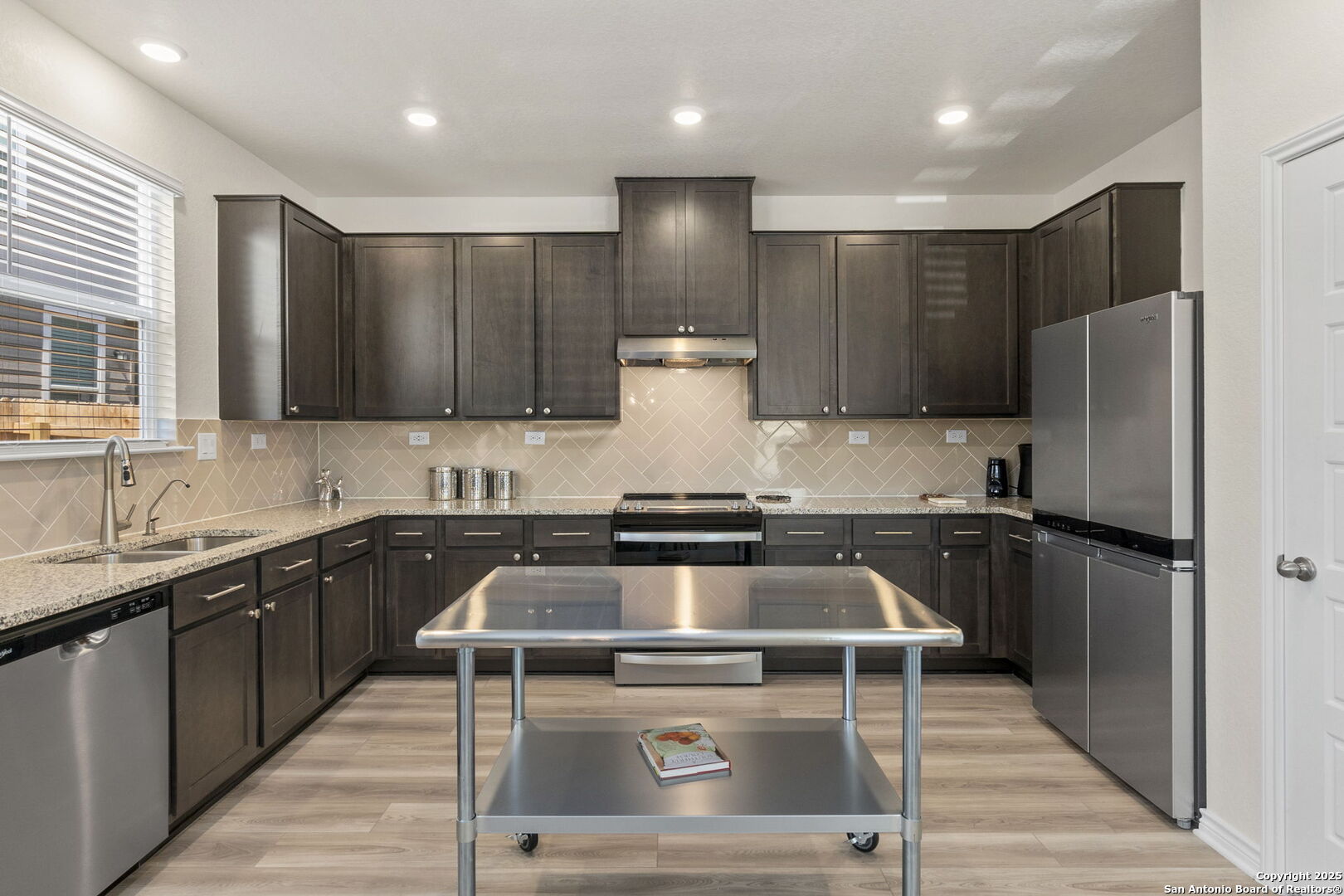 14839 Vance Jackson Road, Unit 1101 San Antonio, TX 78249 - Photo 10 of 31 a kitchen with stainless steel appliances granite countertop a stove a sink and a refrigerator