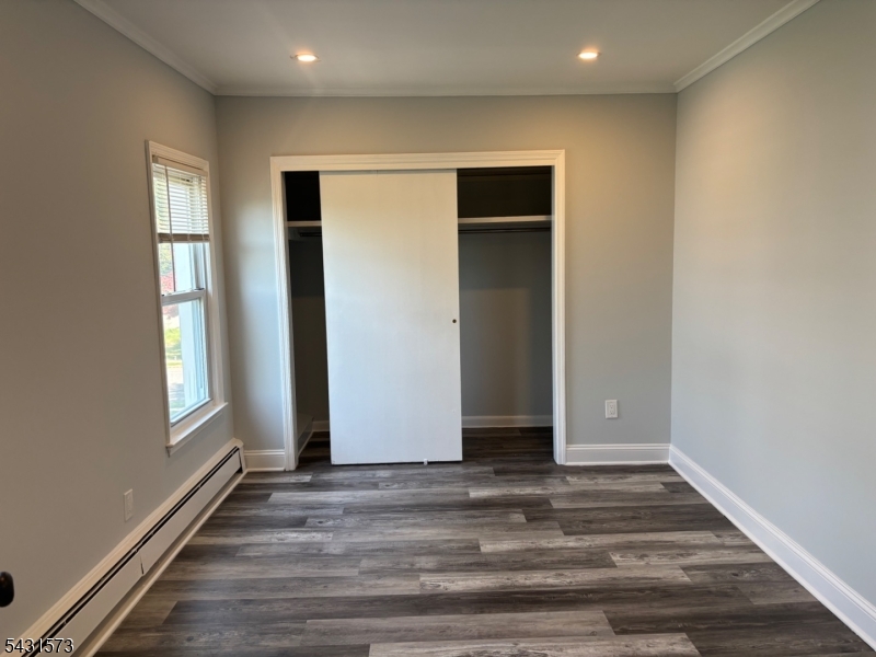 358 Woodland Road, Unit 2 Madison, NJ 07940 - Photo 22 of 50 an empty room with wooden floor and windows