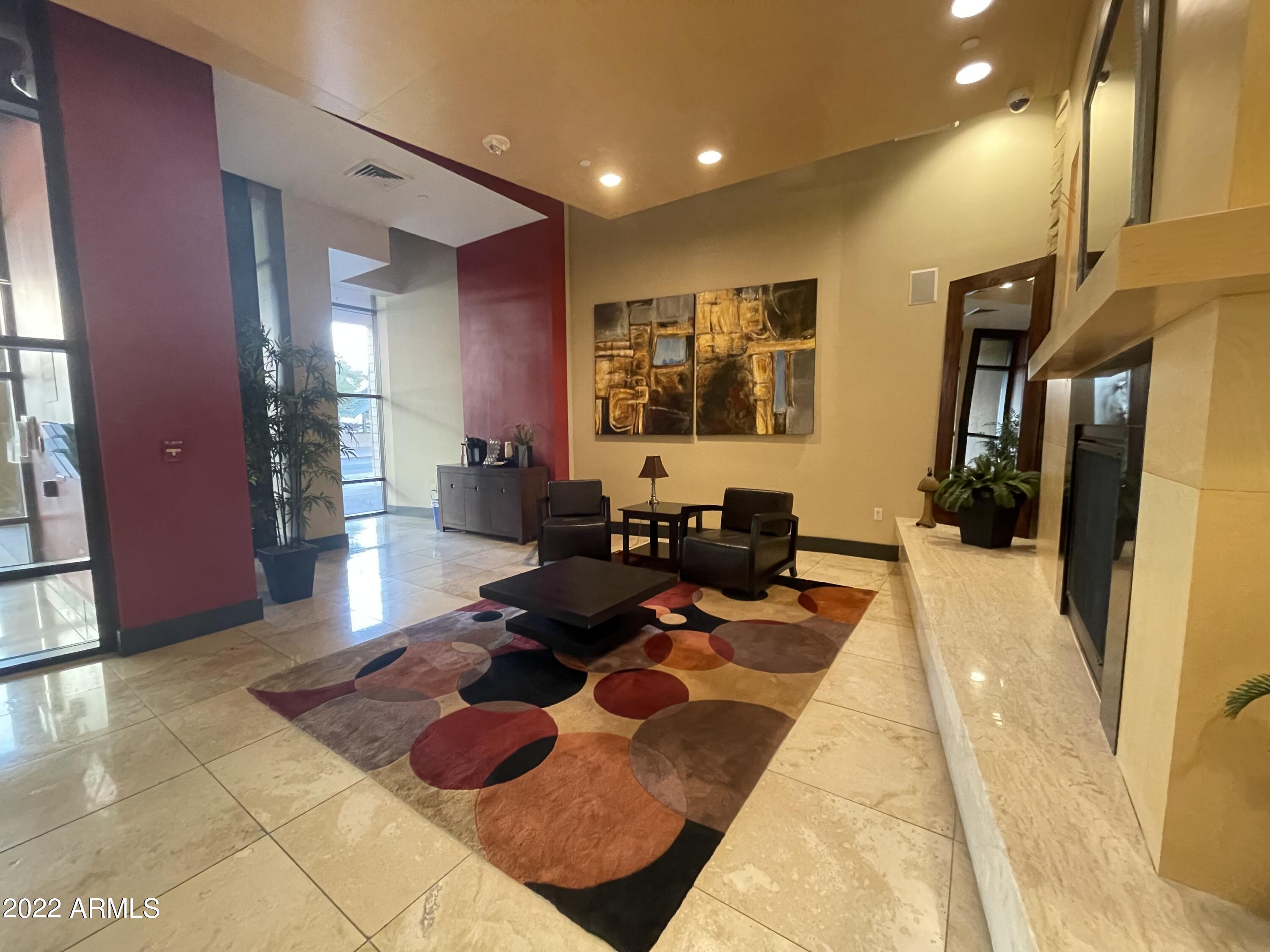 310 South 4th Street, Unit 1507 Phoenix, AZ 85004 - Photo 11 of 24 a living room with furniture rug and a large window
