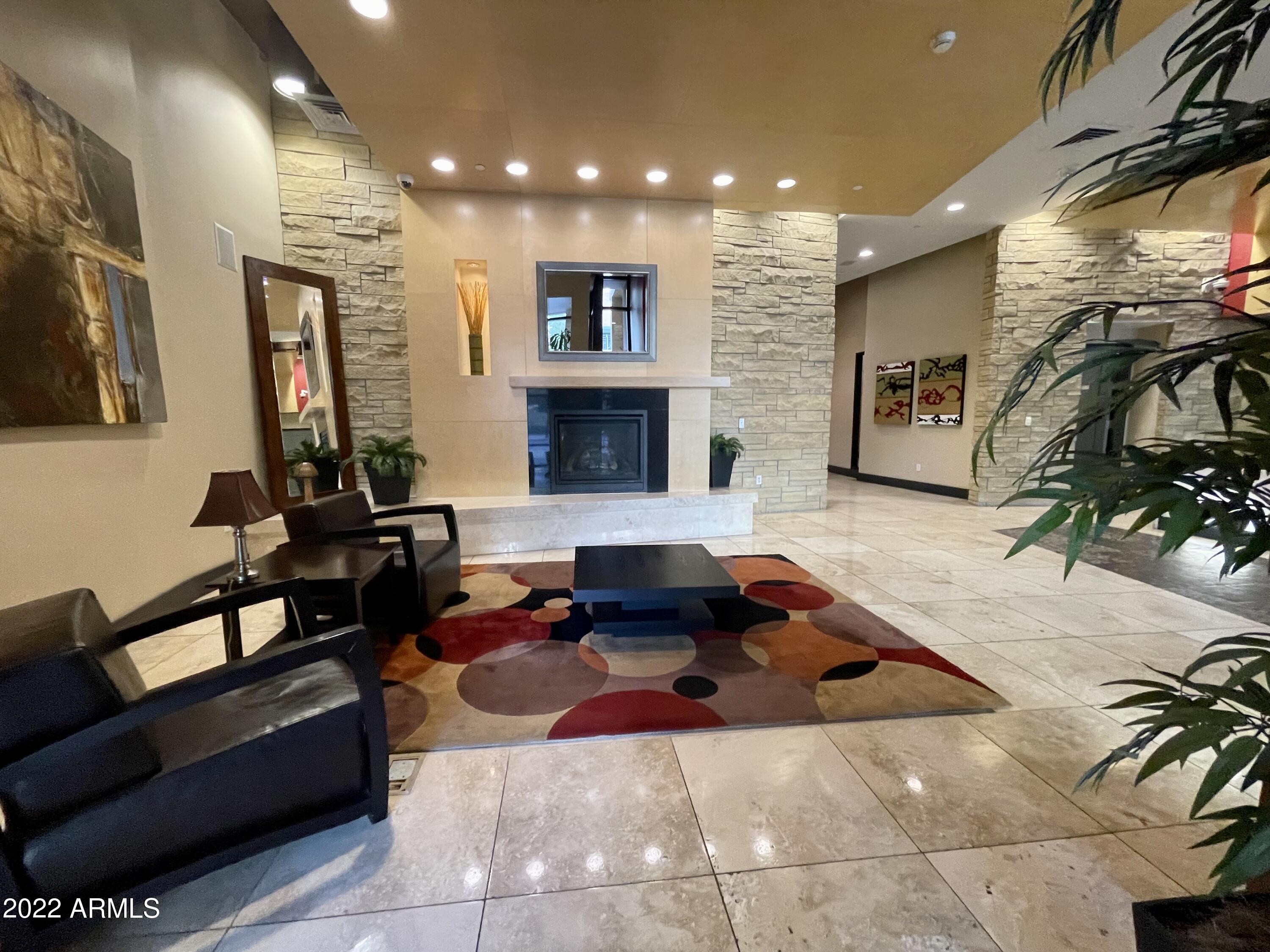 310 South 4th Street, Unit 1507 Phoenix, AZ 85004 - Photo 12 of 24 a living room with furniture and a fireplace