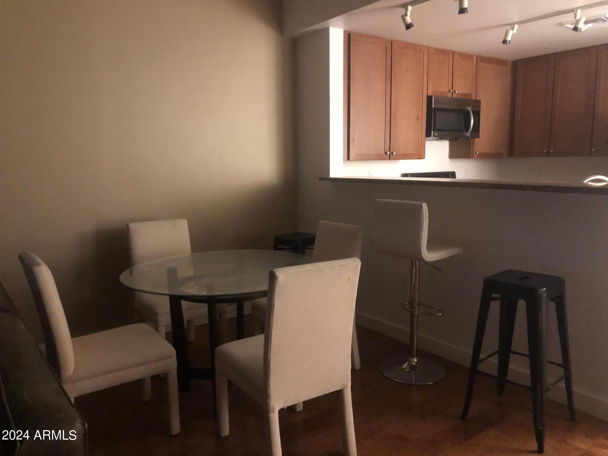 310 South 4th Street, Unit 1507 Phoenix, AZ 85004 - Photo 22 of 24 a view of a dining room with furniture