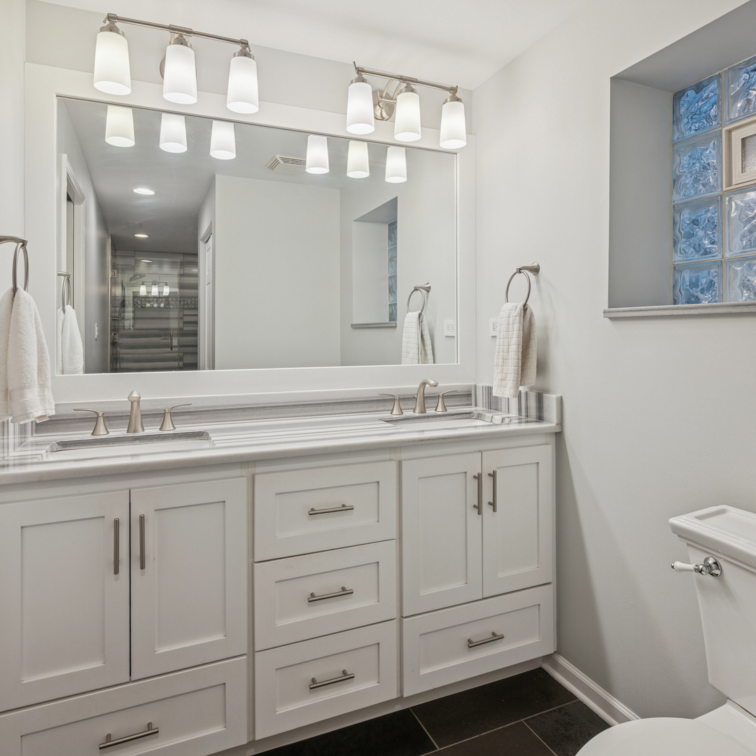 1329 North Mohawk Street, Unit 1 Chicago, IL 60610 - Photo 16 of 25 a bathroom with double sink and a mirror