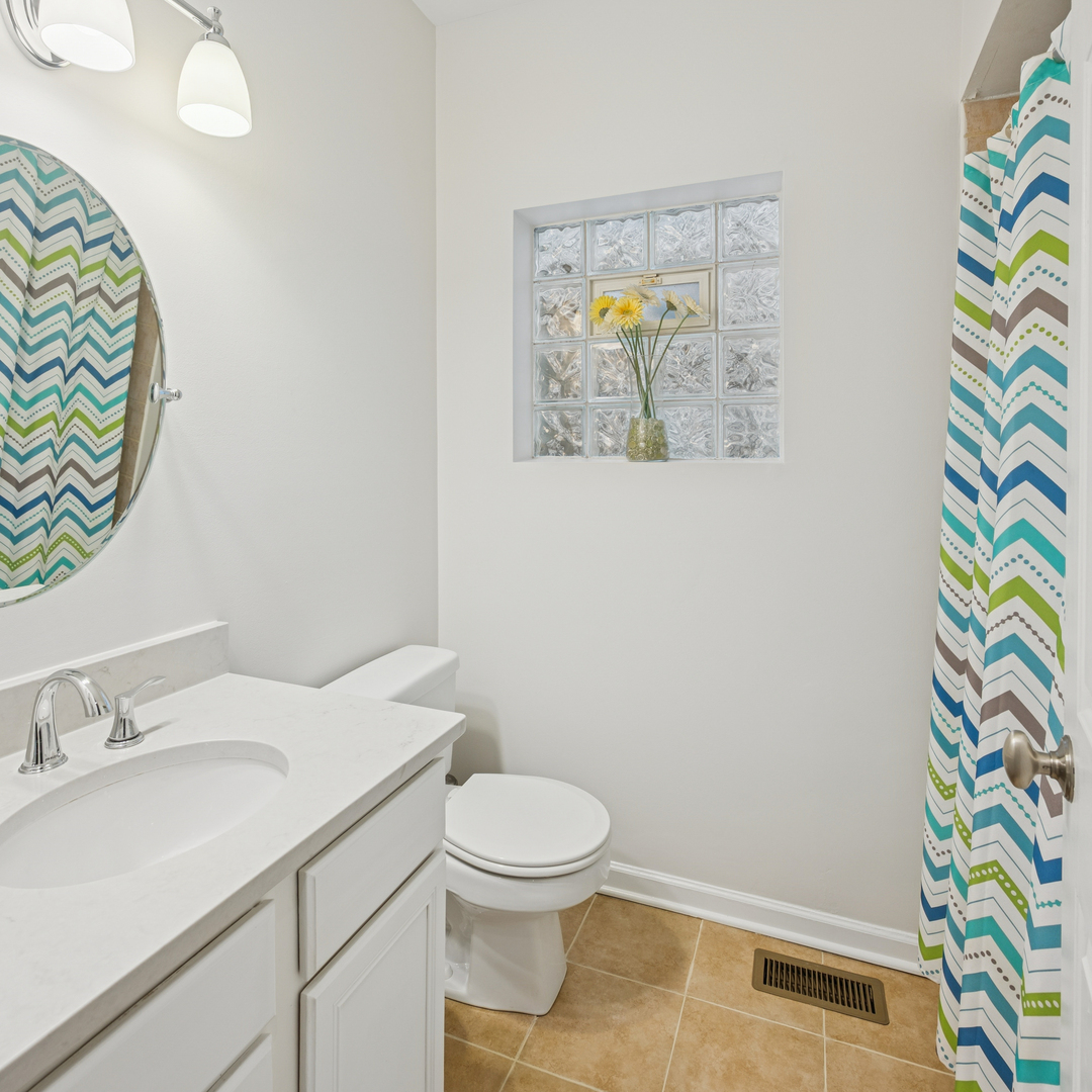 1329 North Mohawk Street, Unit 1 Chicago, IL 60610 - Photo 19 of 25 a bathroom with a sink a toilet and a mirror