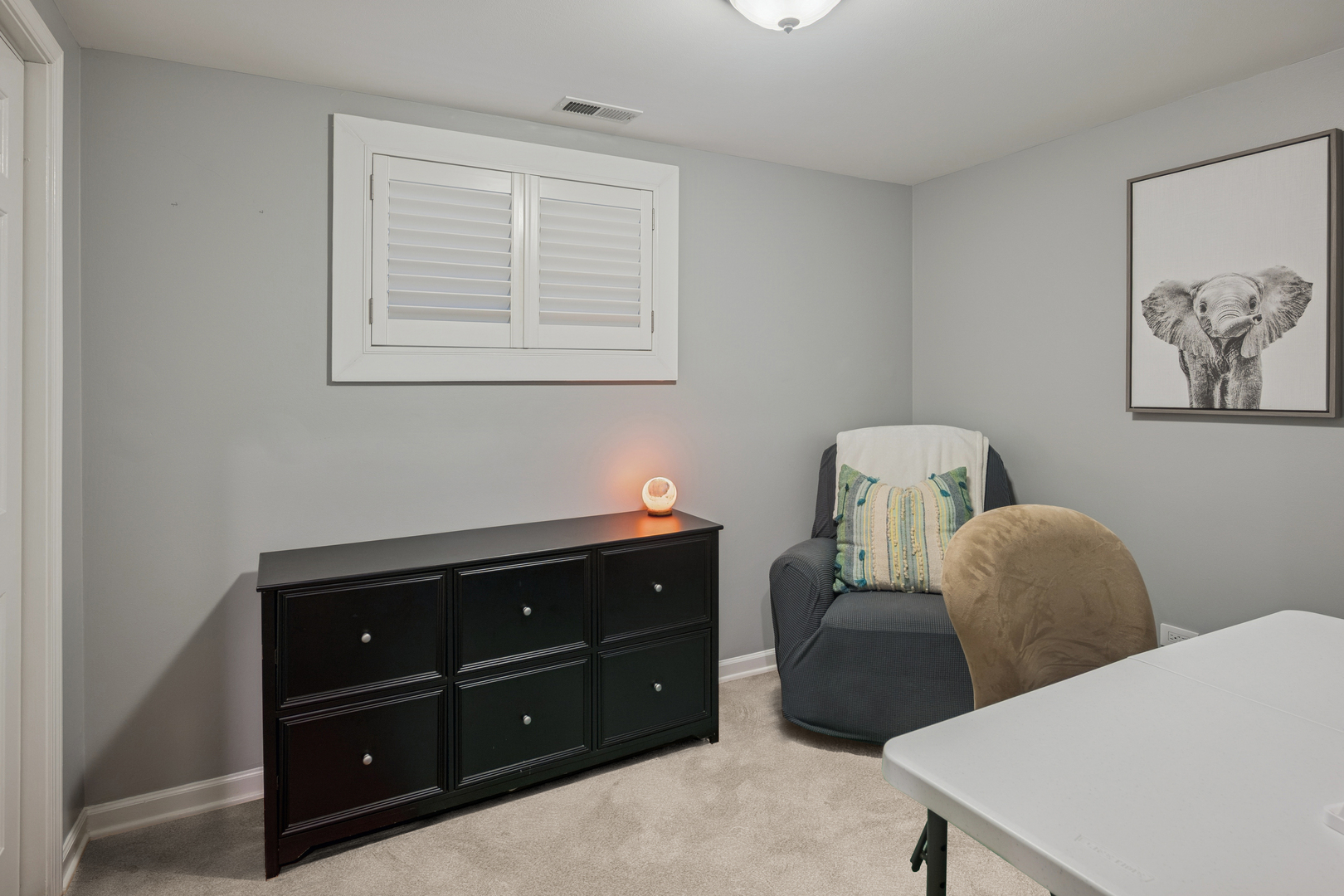 1329 North Mohawk Street, Unit 1 Chicago, IL 60610 - Photo 22 of 25 a room with a lamp and a dresser