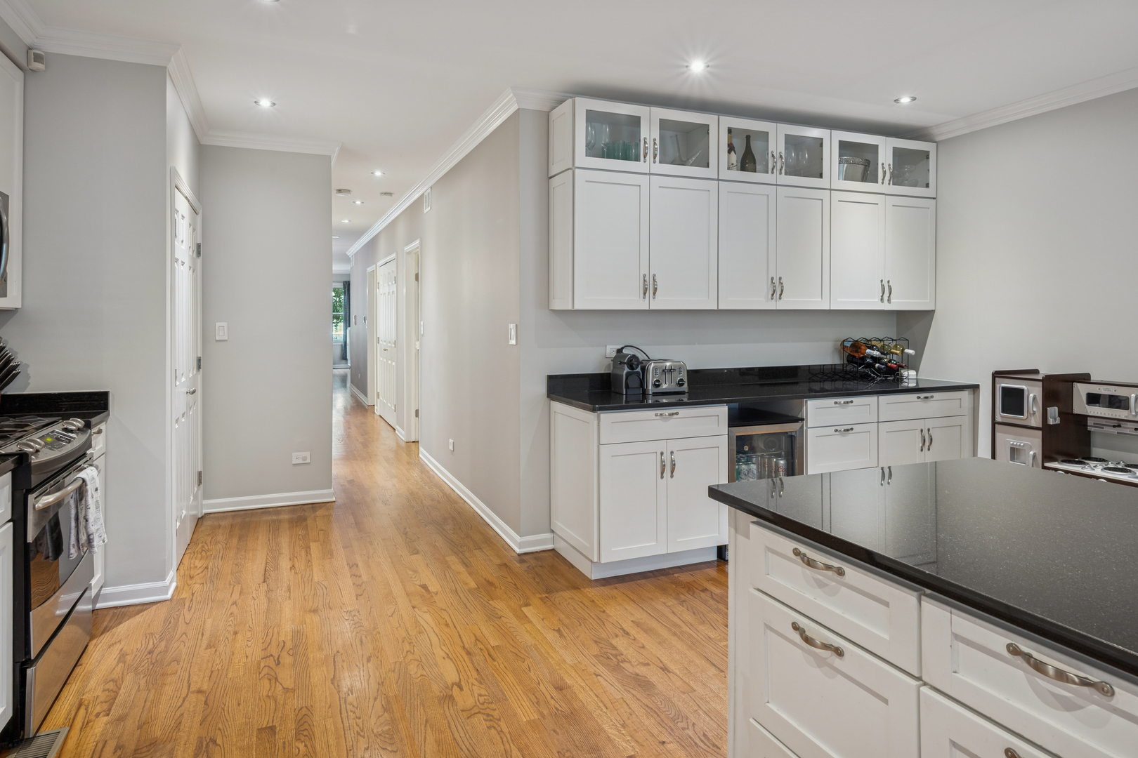 1329 North Mohawk Street, Unit 1 Chicago, IL 60610 - Photo 9 of 25 a kitchen with granite countertop a sink a stove and refrigerator