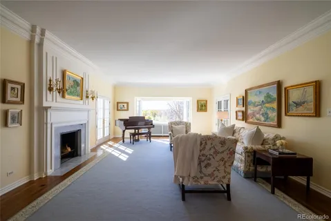 a dining room with furniture a chandelier and wooden floor