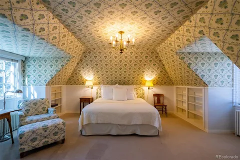an empty room with wooden floor fireplace and windows