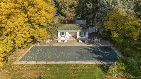 a view of a house with a swimming pool and a yard