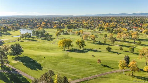a view of a livingroom with furniture wooden floor and a window