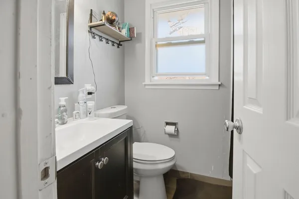 a bathroom with a sink a toilet and mirror