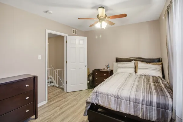 a bedroom with a bed and a chandelier