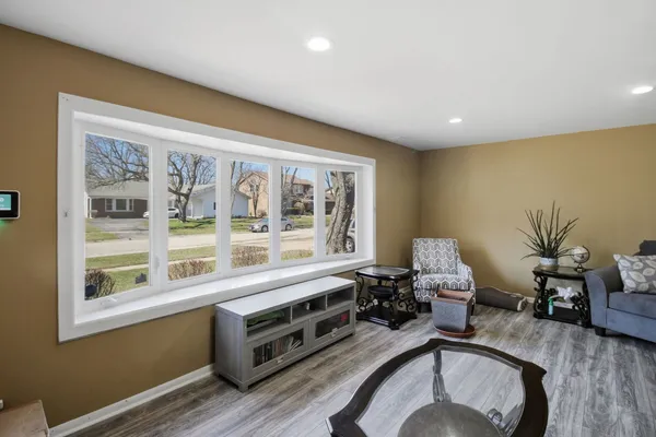 a living room with furniture and a floor to ceiling window