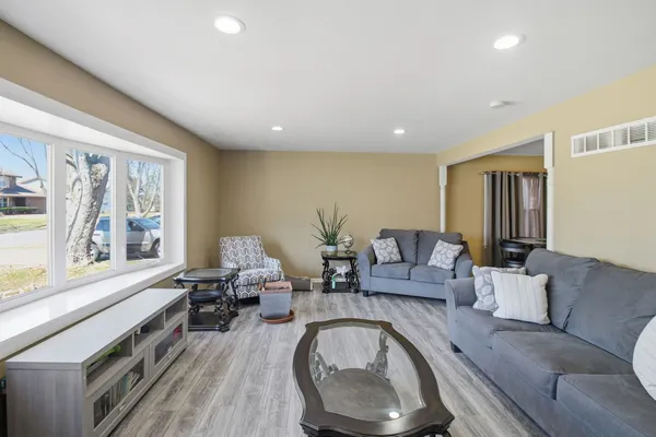 a living room with furniture and a large window