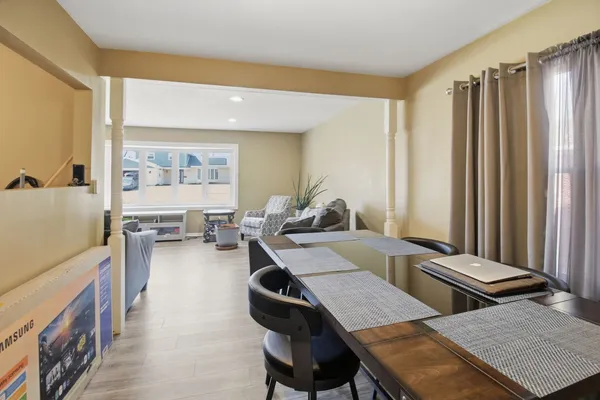 a view of a dining room with furniture and a window