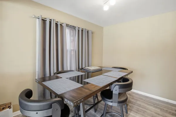 a view of a dining room with furniture and wooden floor