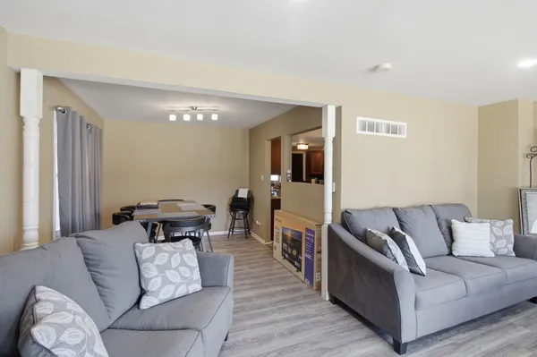 a living room with furniture and a wooden floor