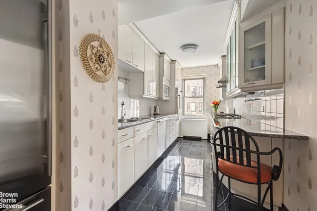 a kitchen with stainless steel appliances granite countertop a refrigerator and a stove top oven