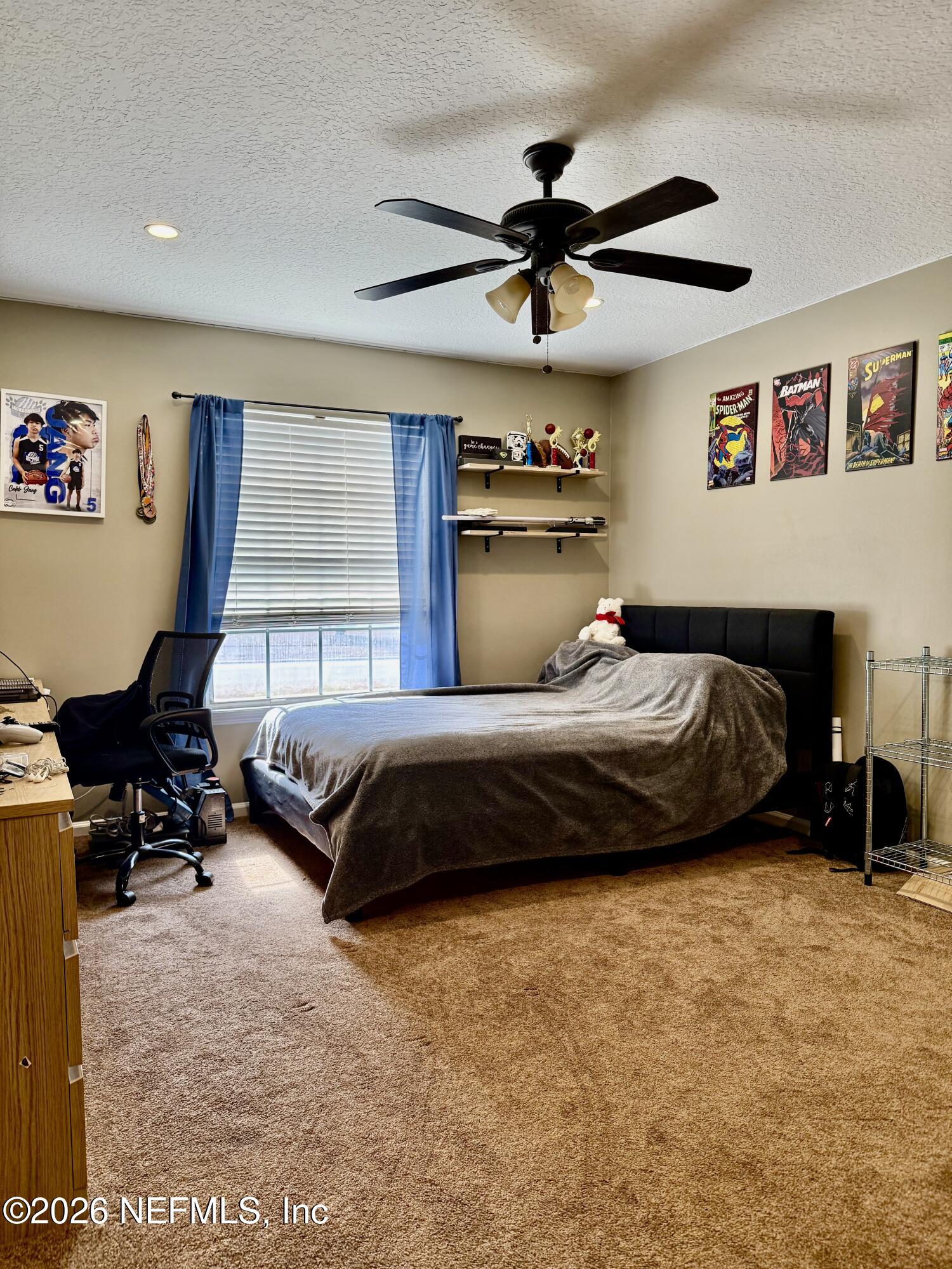 12579 Fish Hawk Lane Jacksonville, FL 32225 - Photo 6 of 11 a bedroom with a bed couch and a window