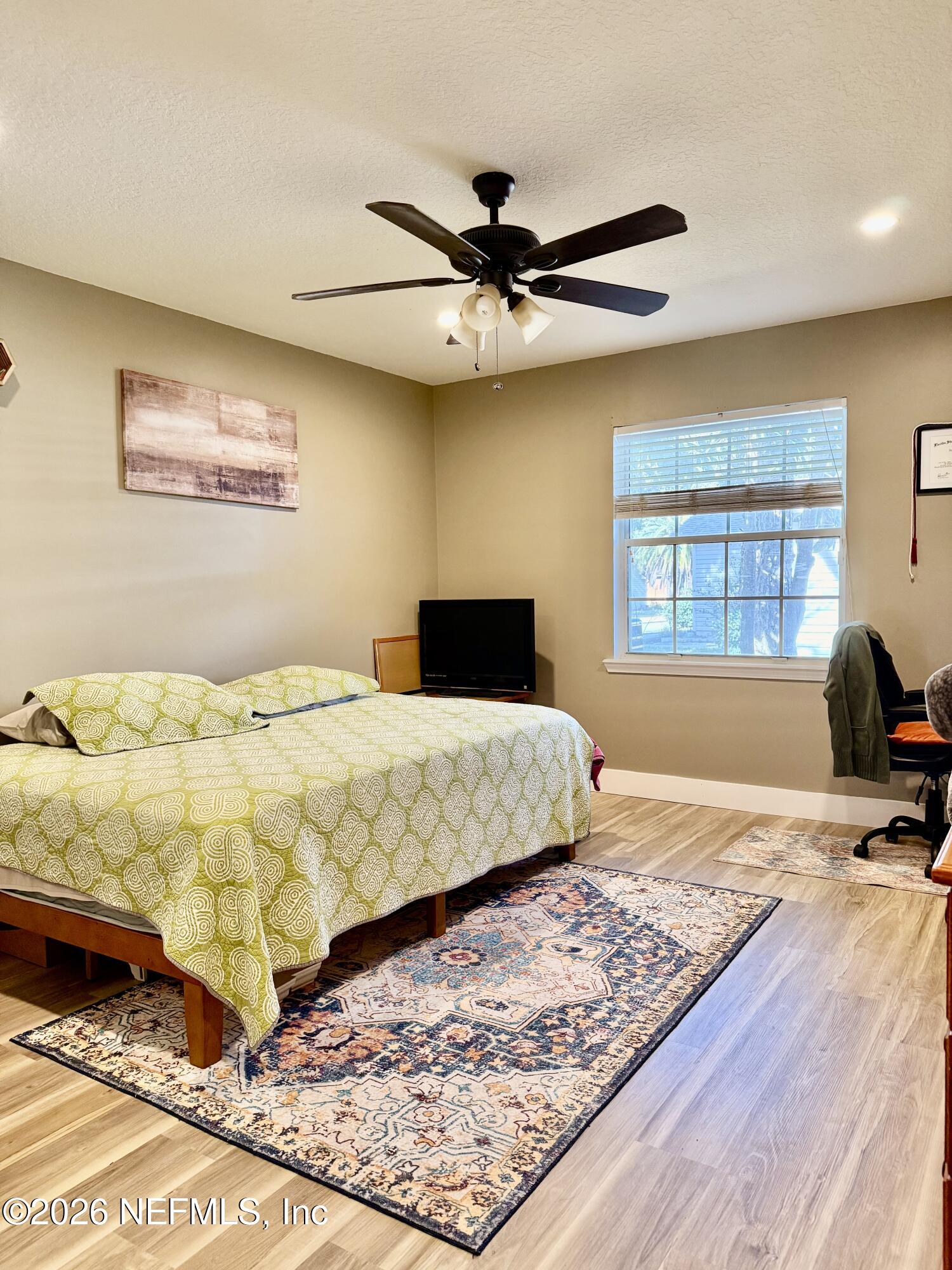 12579 Fish Hawk Lane Jacksonville, FL 32225 - Photo 7 of 11 a bedroom with a bed and wooden floor