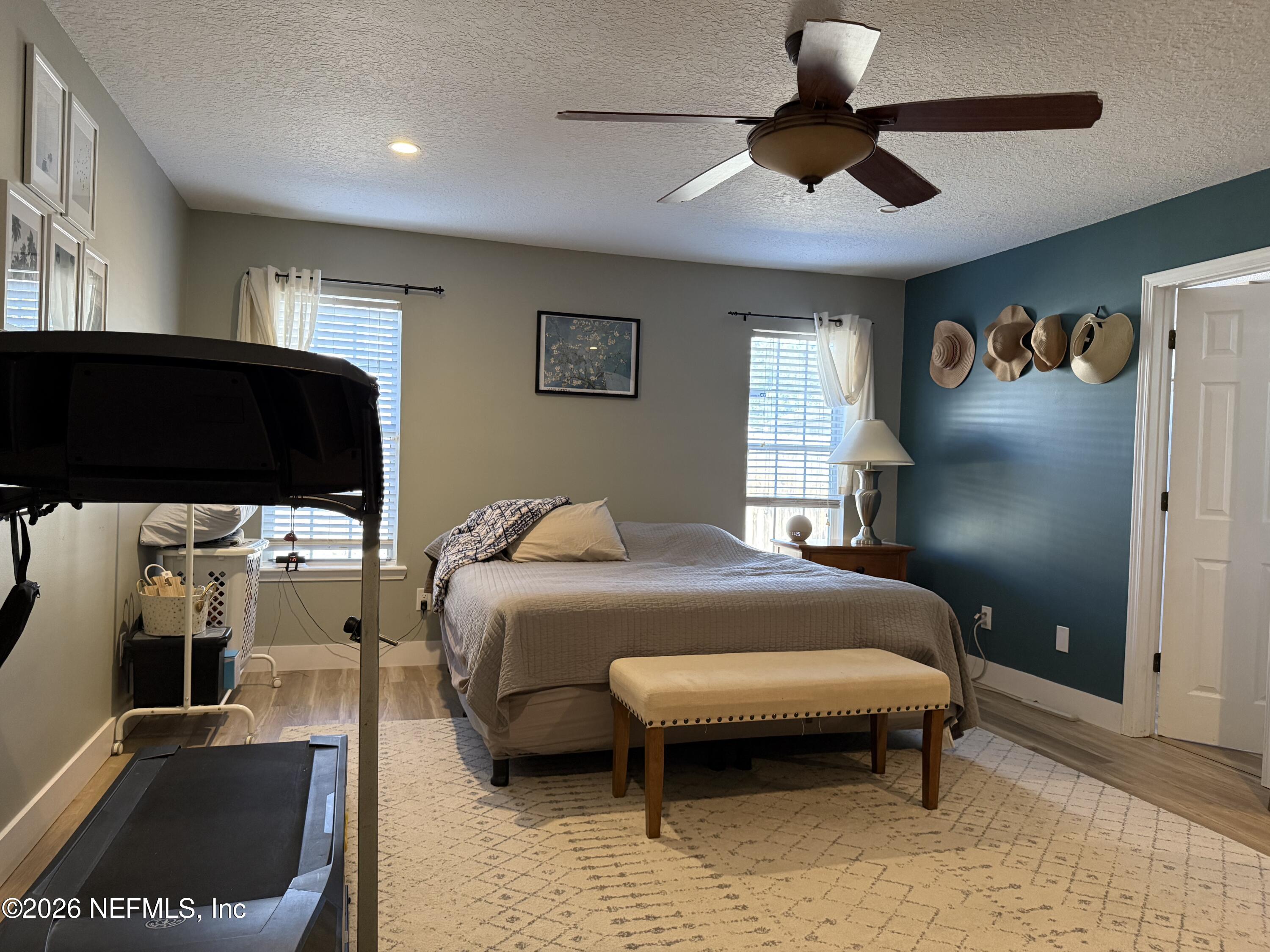 12579 Fish Hawk Lane Jacksonville, FL 32225 - Photo 8 of 11 a bedroom with a bed and a chandelier