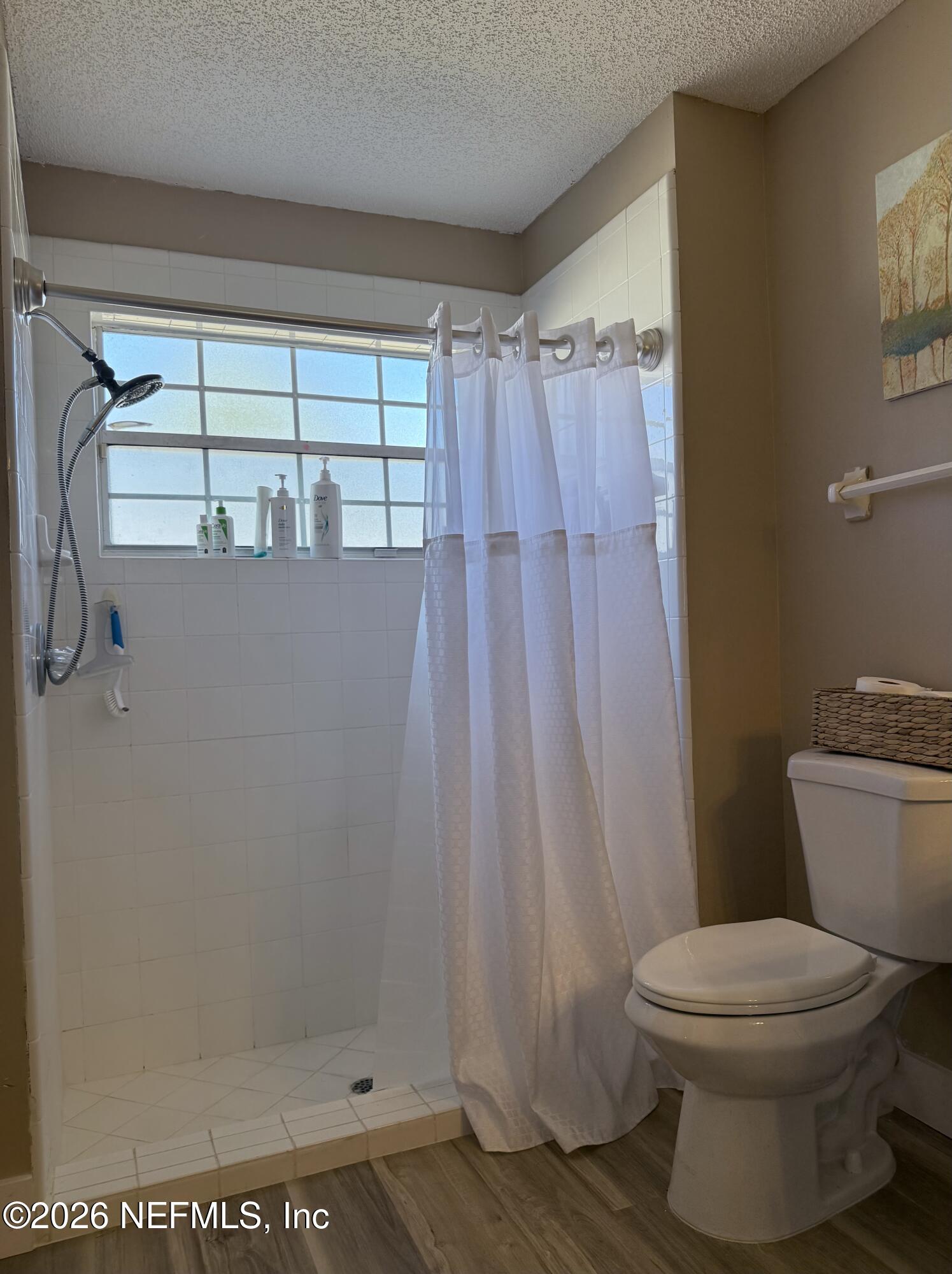 12579 Fish Hawk Lane Jacksonville, FL 32225 - Photo 10 of 11 a bathroom with a toilet and a shower