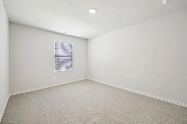 an empty room with a empty space and window