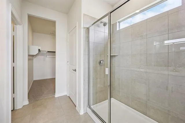 a bathroom with a double vanity sink mirror and shower