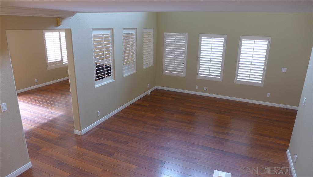 2352 Eastridge Loop Chula Vista, CA 91915 - Photo 13 of 21 an empty room with wooden floor and windows