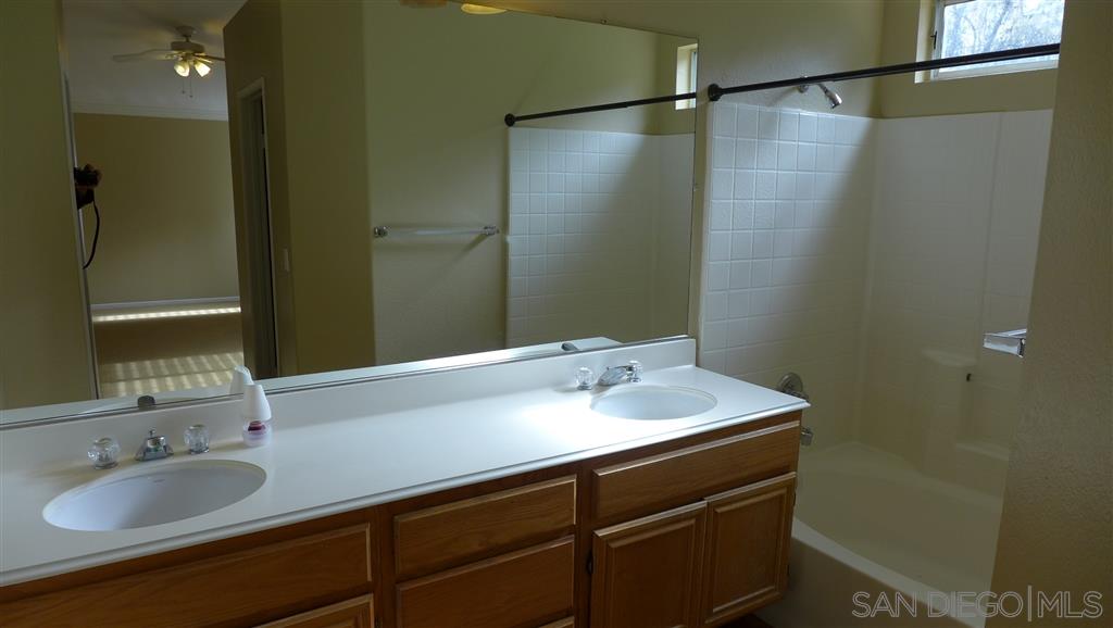 2352 Eastridge Loop Chula Vista, CA 91915 - Photo 16 of 21 a bathroom with a sink and a mirror
