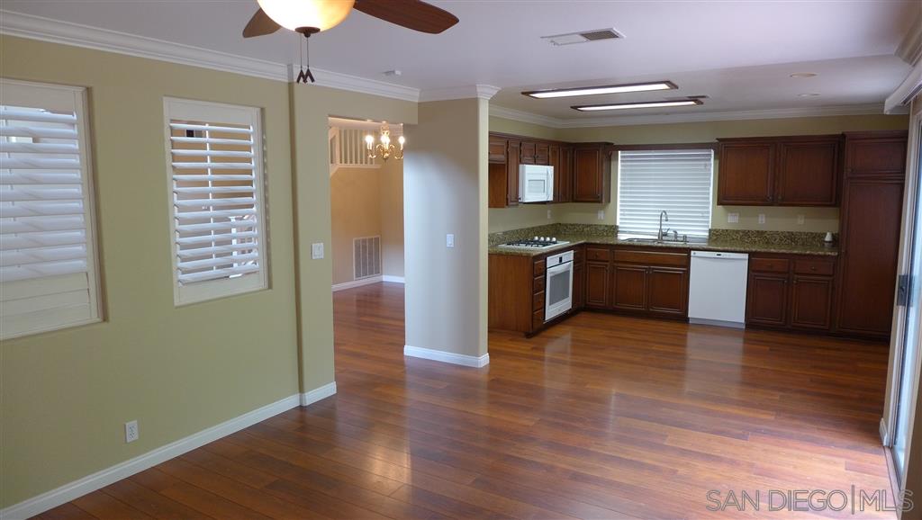 2352 Eastridge Loop Chula Vista, CA 91915 - Photo 5 of 21 a large kitchen with stainless steel appliances granite countertop a stove and a wooden floors