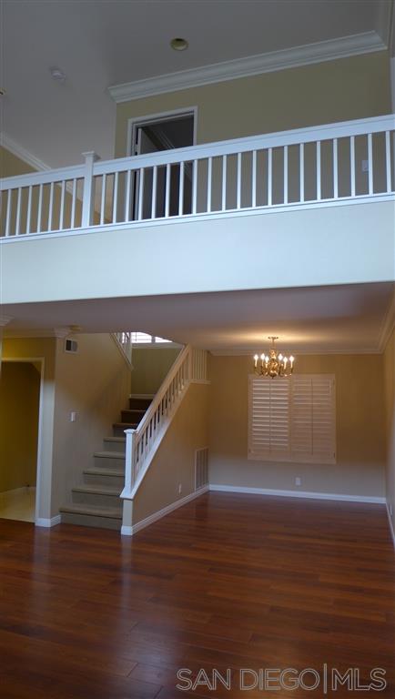 2352 Eastridge Loop Chula Vista, CA 91915 - Photo 9 of 21 a view of an empty room with wooden floor and a window