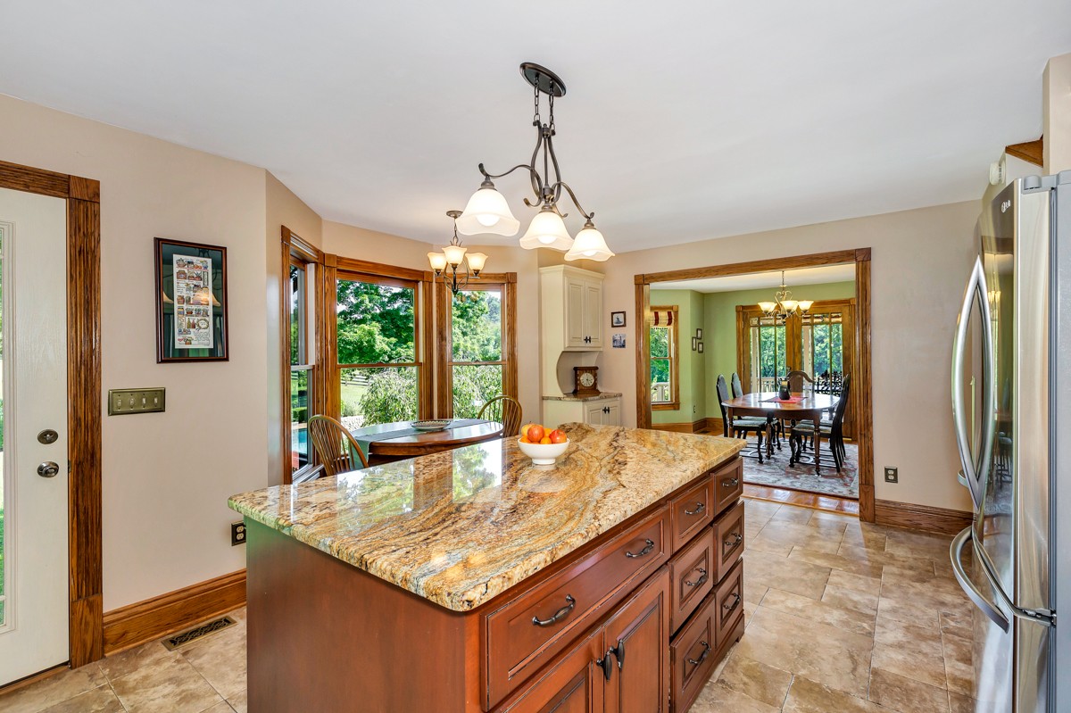 205 Puryear Road Pulaski, TN 38478 - Photo 8 of 36 a kitchen with stainless steel appliances granite countertop counter space and windows