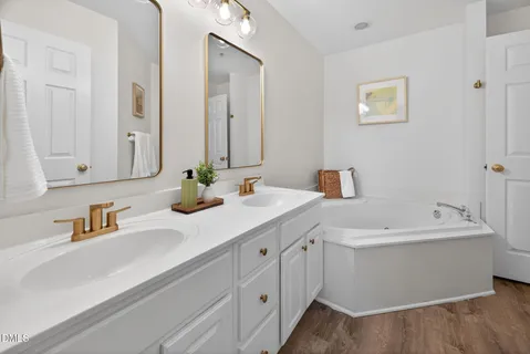 a bathroom with a double vanity sink mirror and