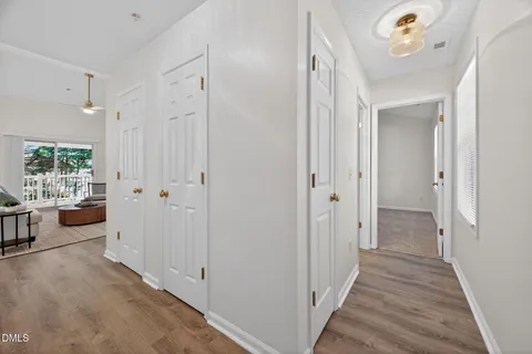 a view of a hallway view with wooden floor and dining room view