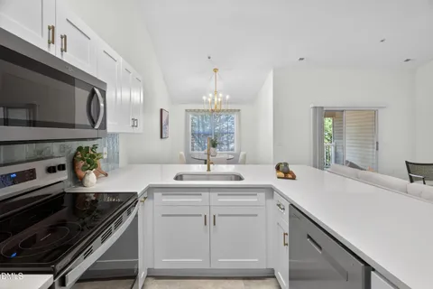 a kitchen with a sink stove and cabinets