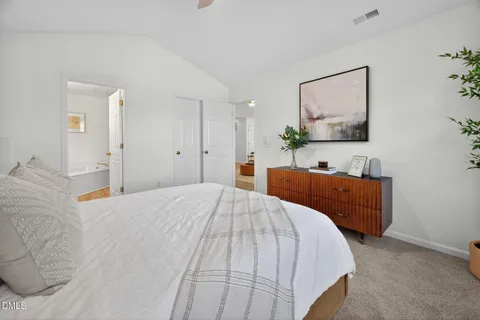 a bed room with a bed and a mirror