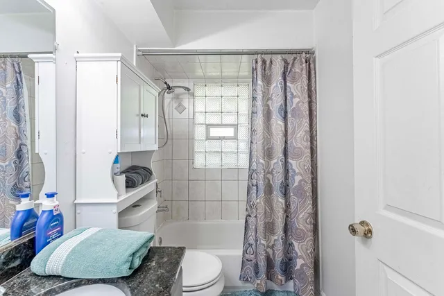 a bathroom with a sink toilet and shower