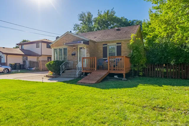 a view of a house with a yard and sitting area