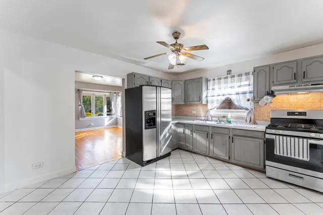 a kitchen with stainless steel appliances a refrigerator and a sink