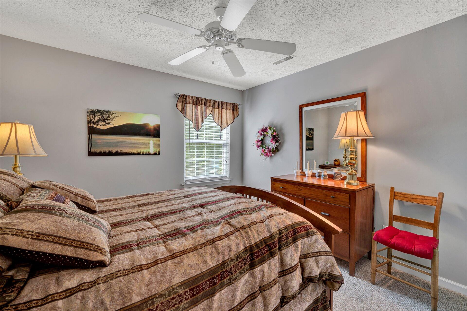 11 Cedar Bay Road Union Hall, VA 24176 - Photo 34 of 60 a bedroom with a bed and a chandelier