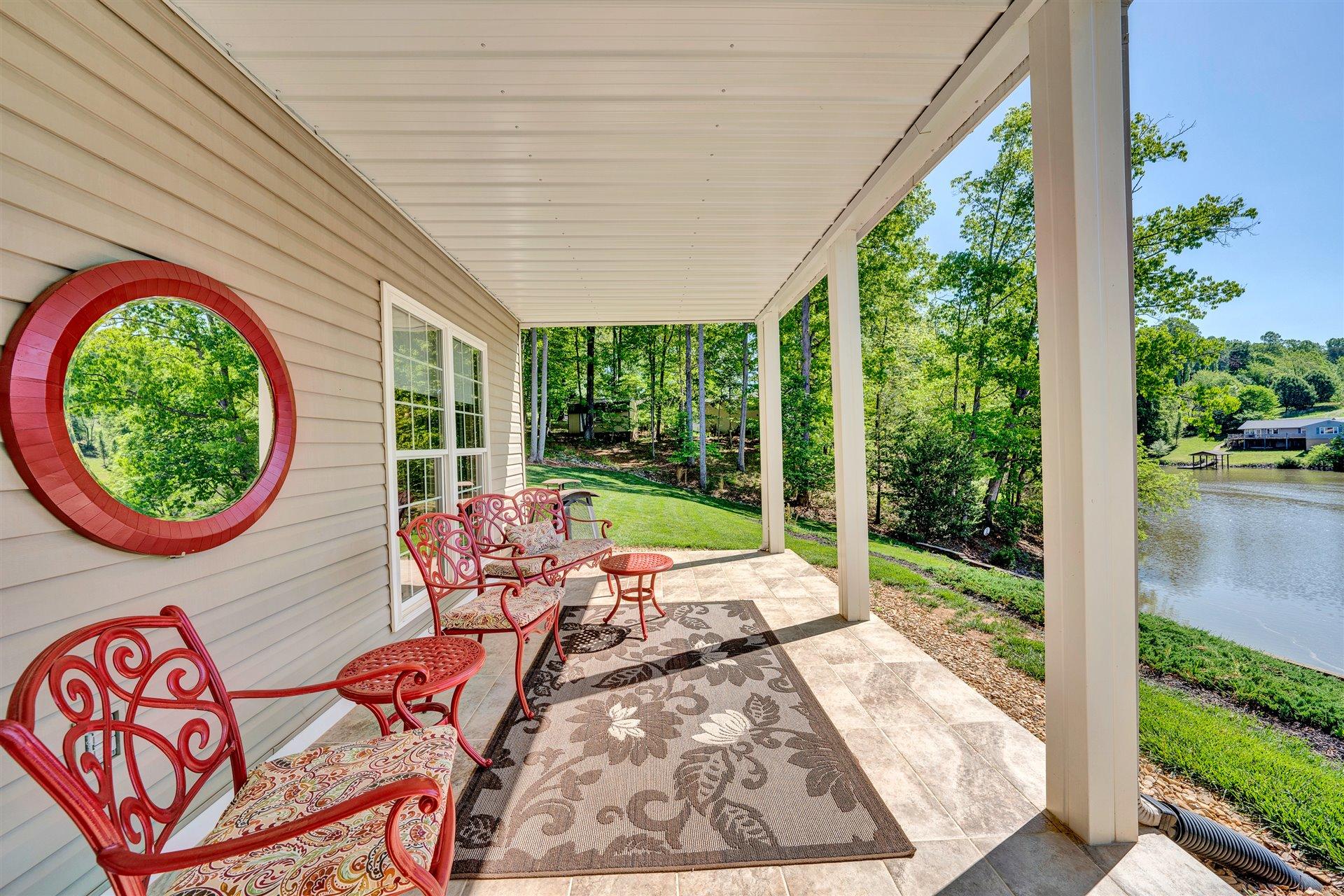 11 Cedar Bay Road Union Hall, VA 24176 - Photo 46 of 60 a view of a patio with table and chairs potted plants with wooden floor and fence