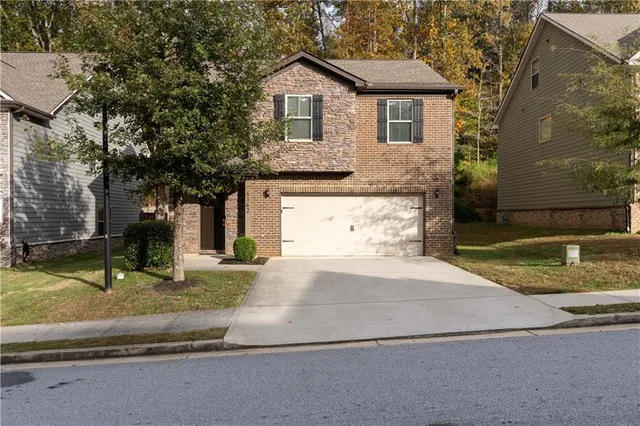 a front view of a house with a yard and garage